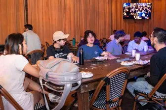 Long tables in the venue, a match on the TV