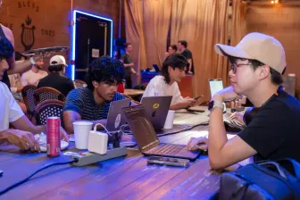 Working at a table under purple light