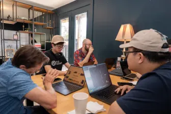 Close in on the table: coffee cups and laptops