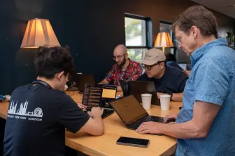 A table of laptops, seen from the side