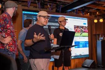 A demo on stage, the presenter mid-sentence